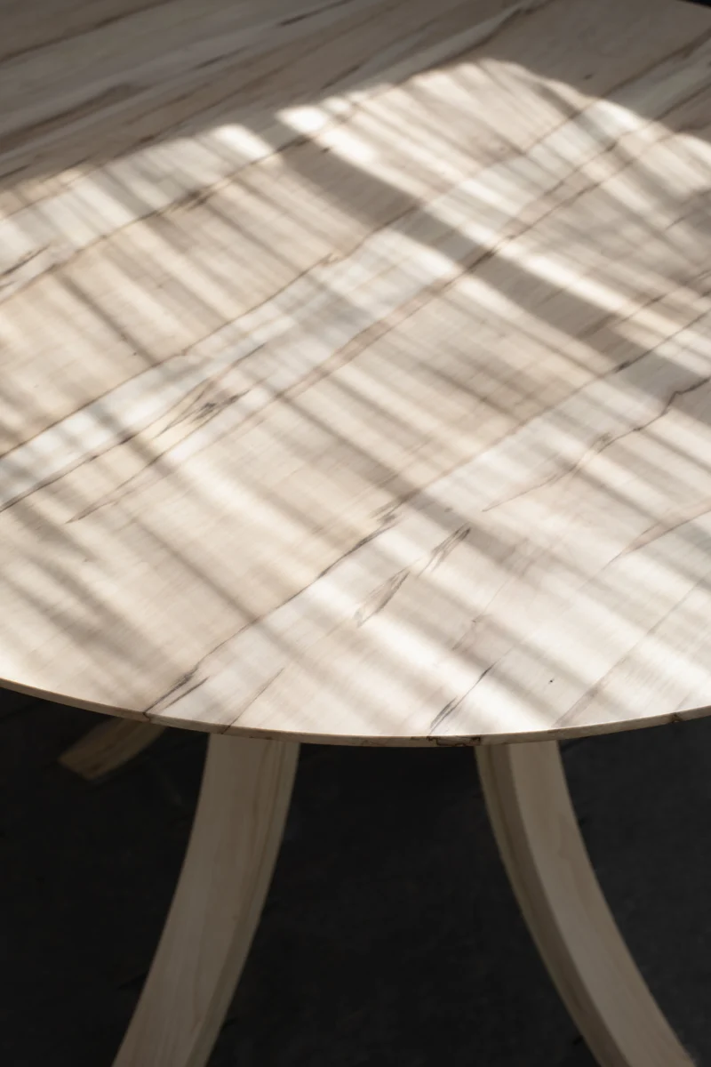 Plateau de table traversé par la lumière, piètement courbe